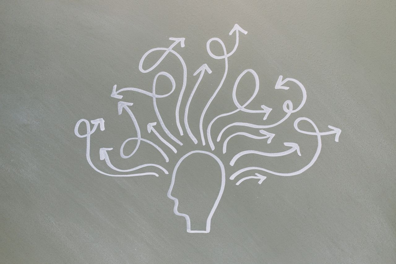 Conceptual chalk drawing illustrating mental health challenges with arrows representing thoughts.